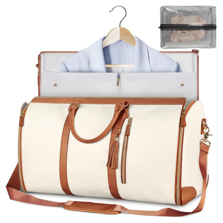 White travel duffle bag with brown trim and handles, open top with hanging clothes