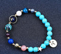 Turquoise beaded bracelet with mixed beads, zodiac charm disks, and a small star charm