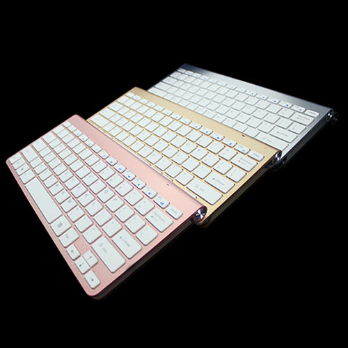 Rose gold wireless mini keyboard and mouse combo in tilted view