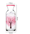 Glass water bottle with pink tree decoration and red rim, 25cm height