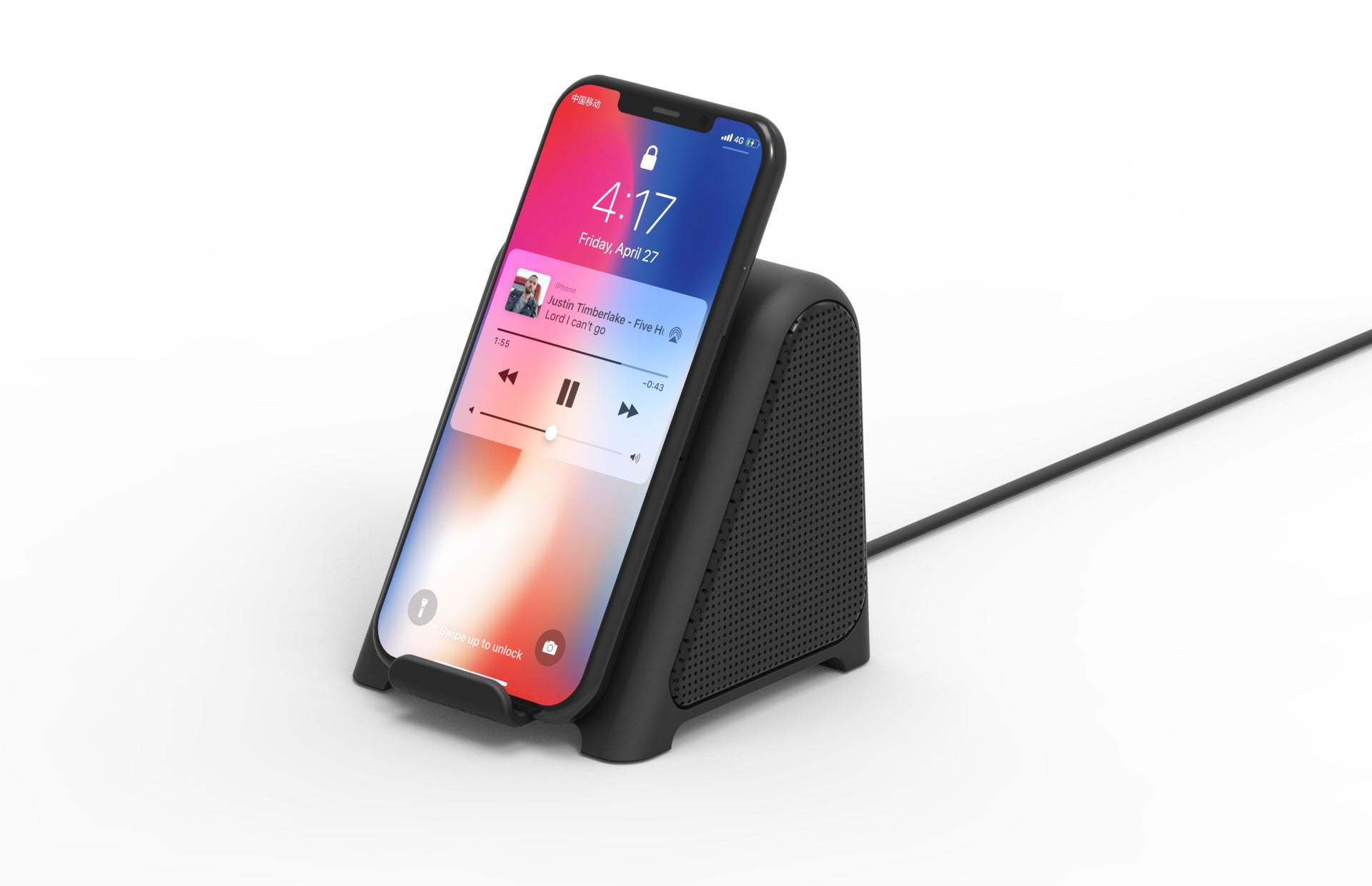 Small black wireless subwoofer speaker dock with phone resting against the front