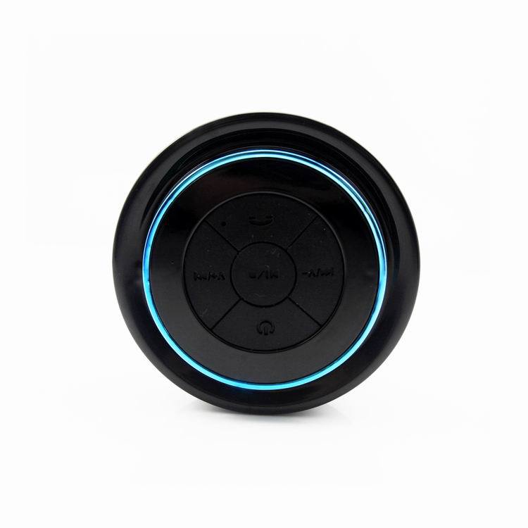 Portable Bluetooth speaker, black body with blue LED ring and circular control panel