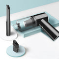 Wireless car vacuum cleaner set with black handheld unit, charging base, and brush.