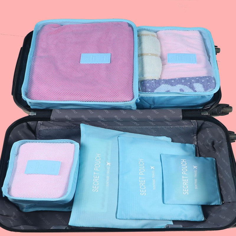 Packing cube set in blue with mesh panels, labeled pouches, and zipper closures