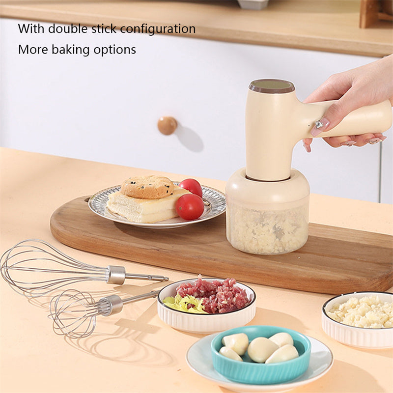 Beige electric chopper held above clear cup with whisk and food bowls