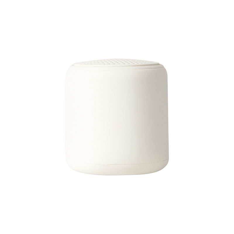 Portable wireless mini speaker, white cylinder with perforated top grille