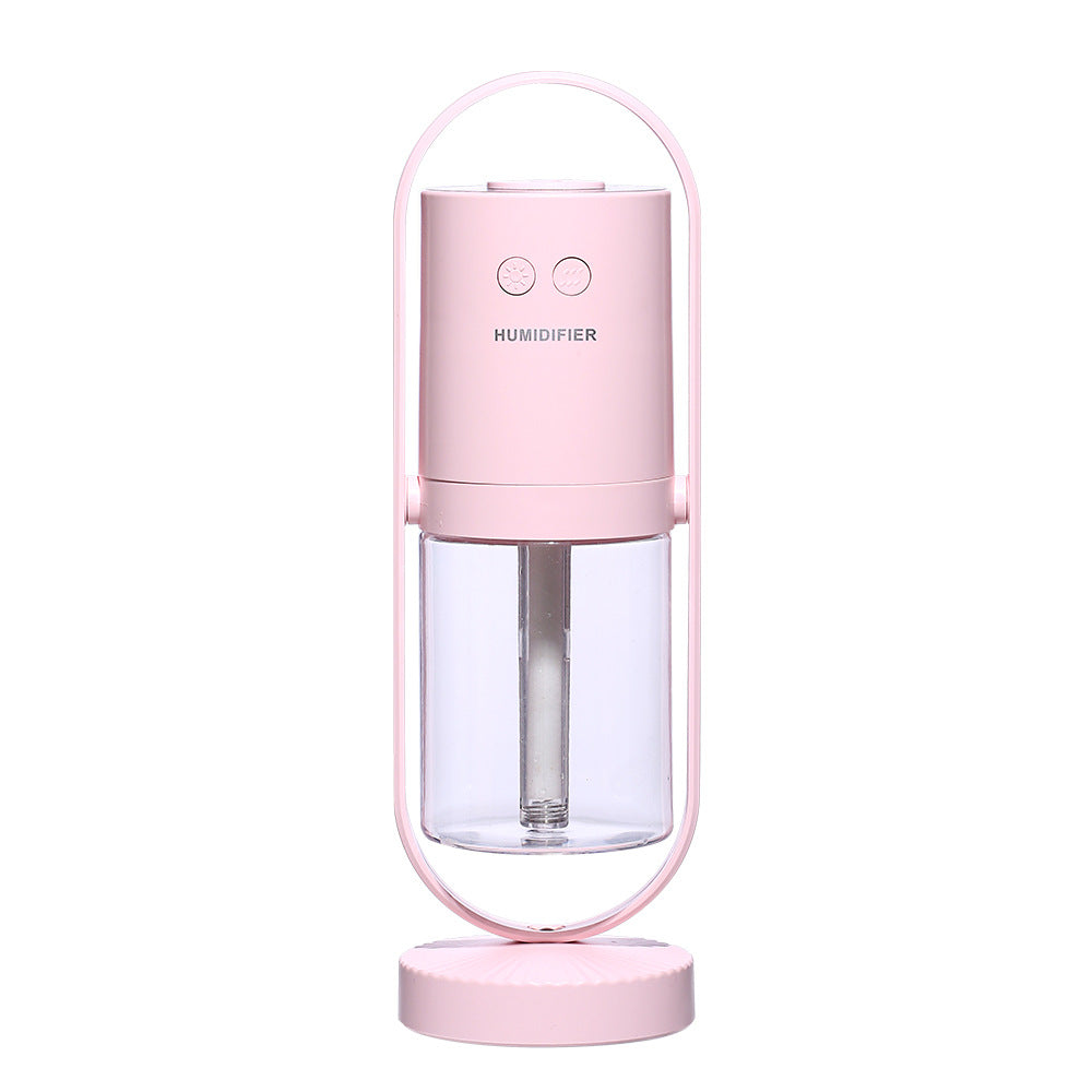 USB air humidifier in pink with clear water tank and round base