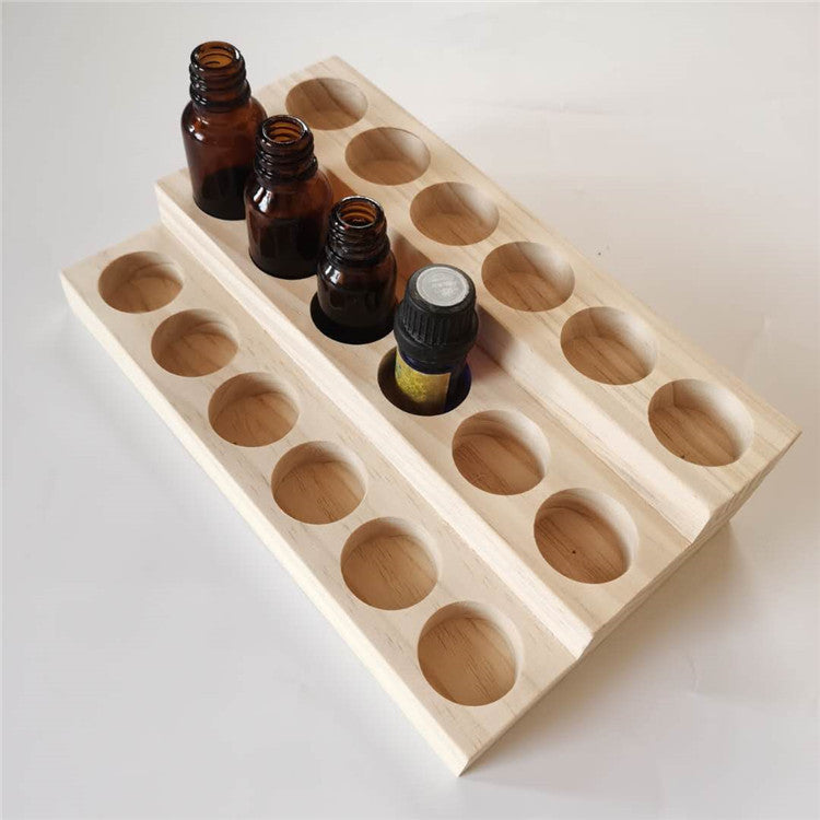Essential oil display stand with empty round bottle holes, light wood, angled view