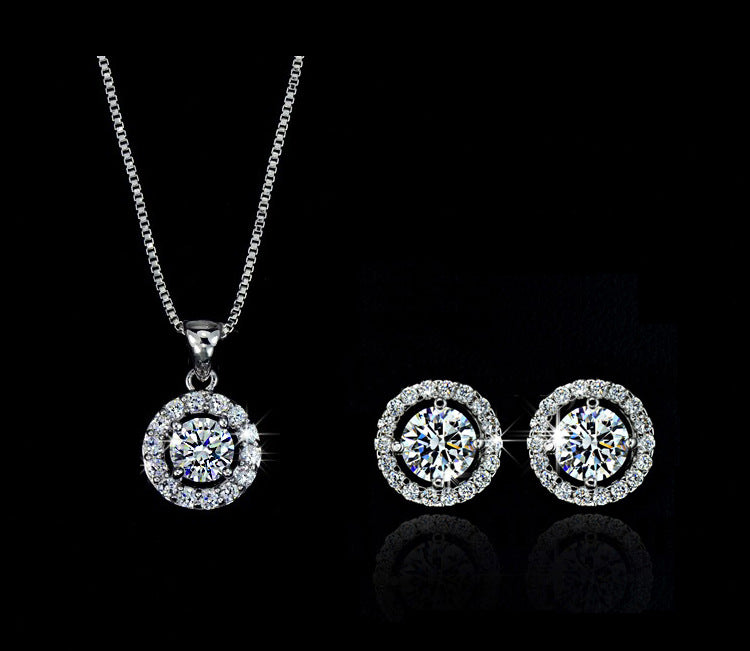 Silver jewelry set with round pendant necklace and two matching stud earrings