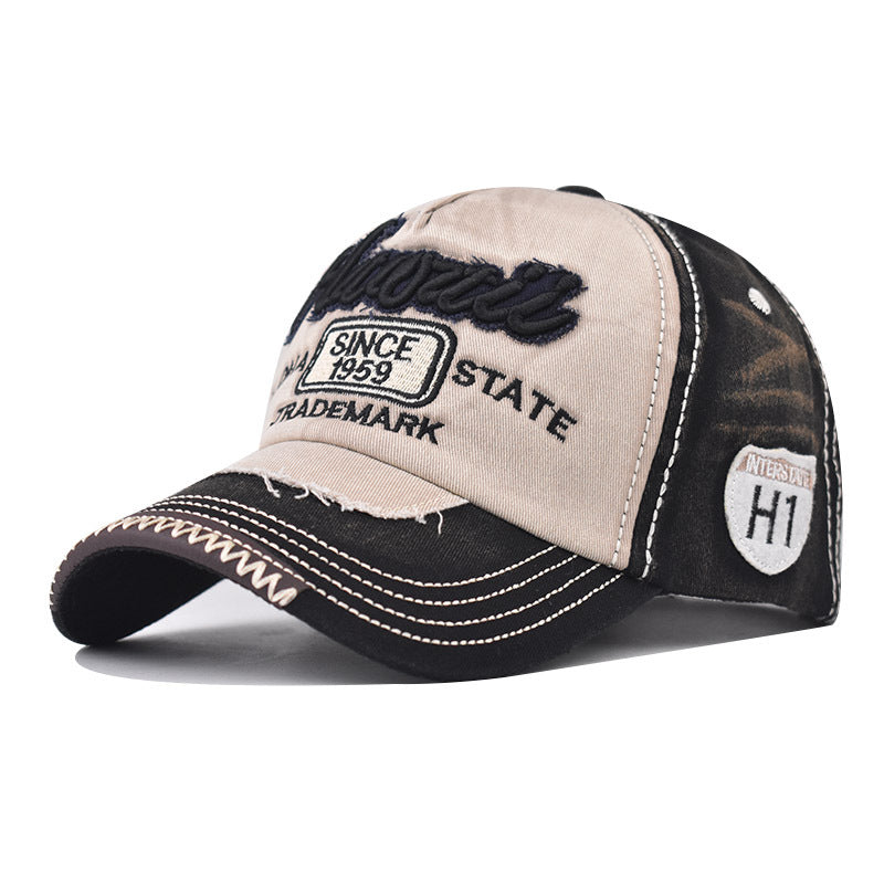 Tan and dark baseball cap with side embroidery, curved brim, and “HI” badge patch