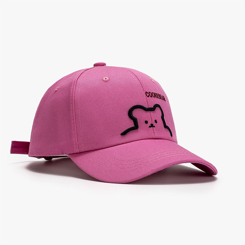 Pink baseball cap with bear outline patch and curved brim