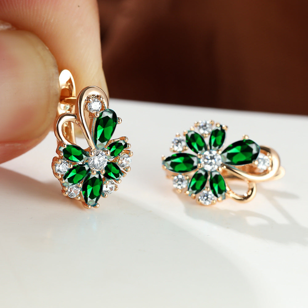 Gold-tone cluster drop earrings with green stones and clear round sparkle accents
