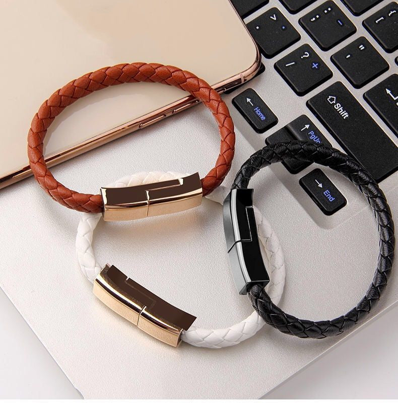 Set of braided charging bracelet cables in white, brown, and black with metal clasps