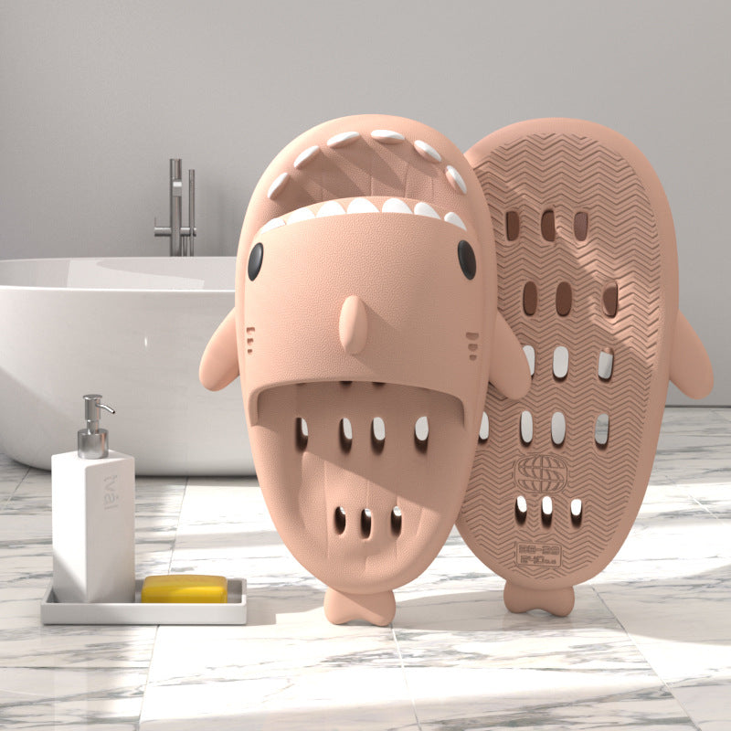 Pink shark-shaped EVA shower slide with drainage holes and textured sole