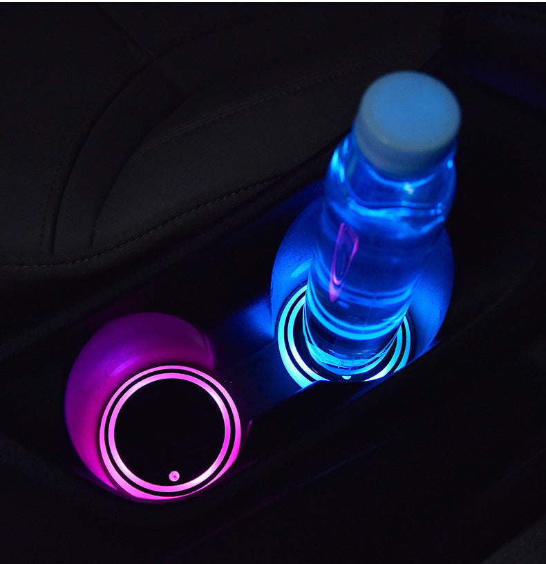 LED light-up coaster beside a bottle, purple and blue glowing circular rings