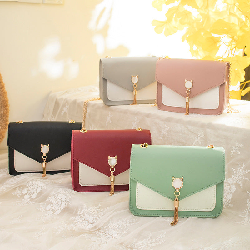Set of small messenger bags with cat charm flap clasps and gold chain straps