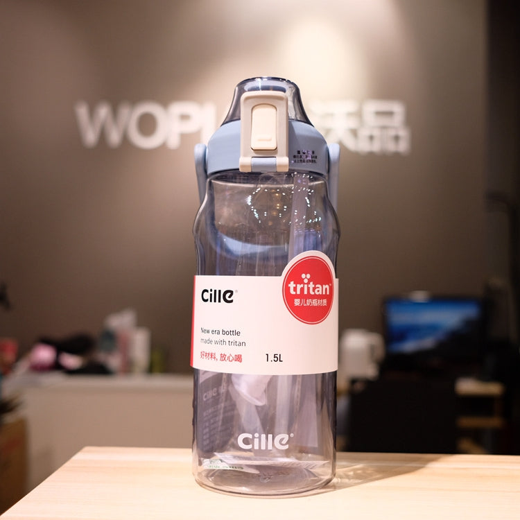 Cille water bottle with straw and blue scaled sleeve, clear body, flip lid