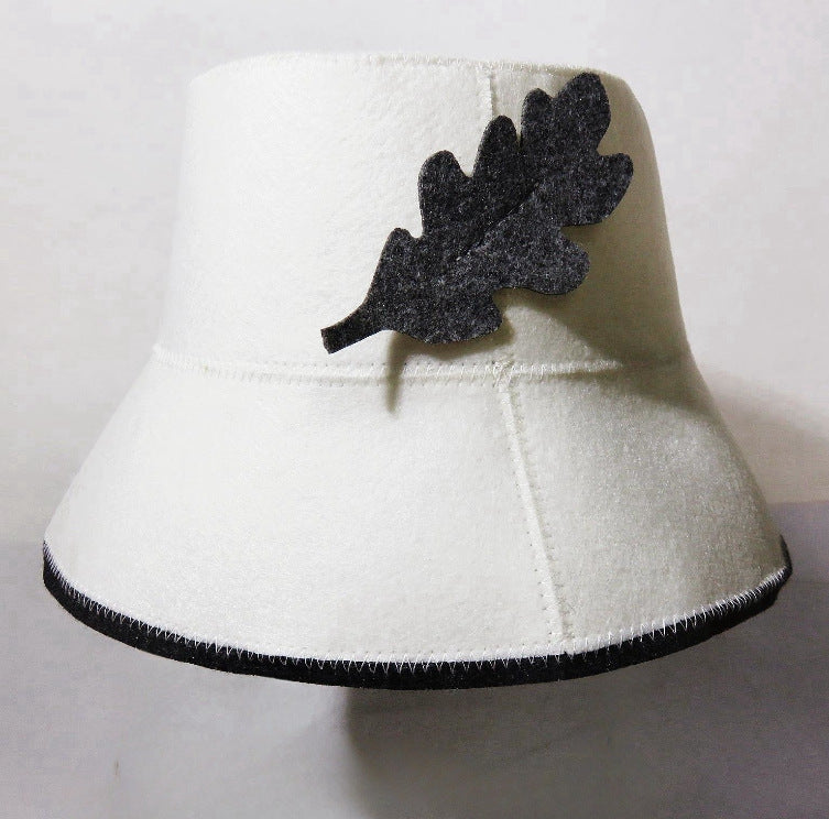 White wool bucket hat with dark leaf felt applique and contrast edge stitching