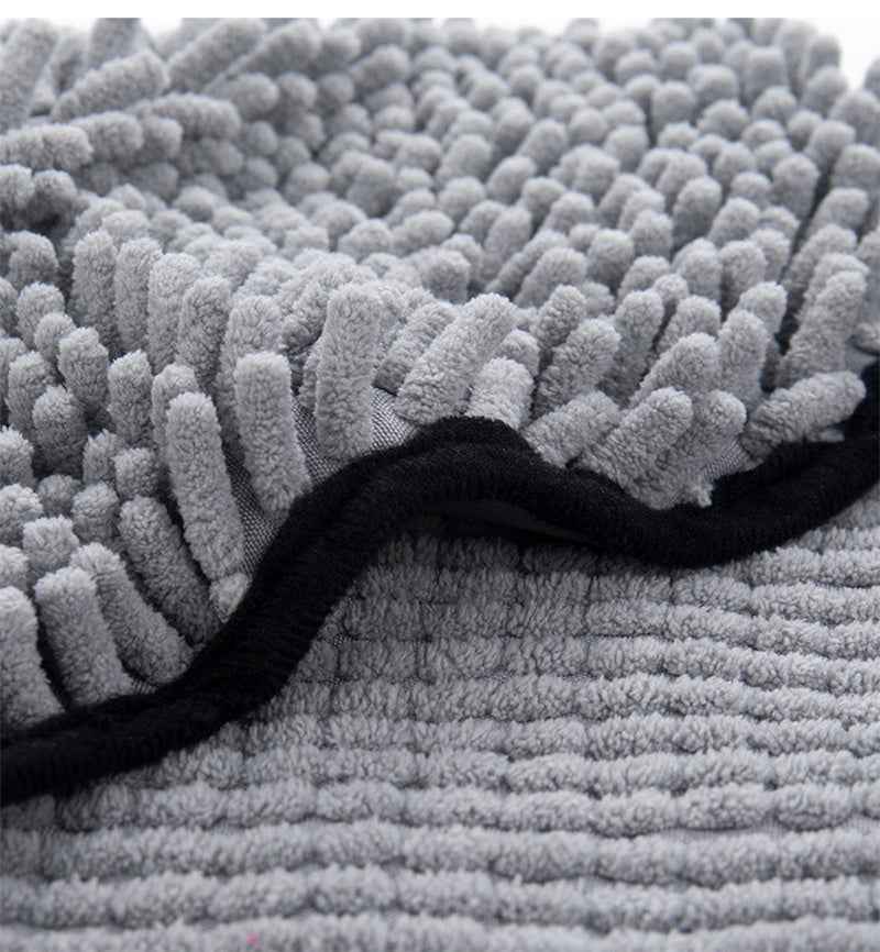 Close-up of gray microfiber pet towel with thick looped shag texture and black edge