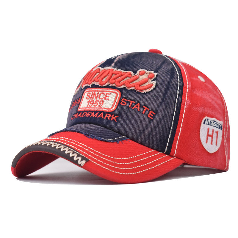 Two-tone cowboy style baseball cap with red brim and dark crown, embroidered patches